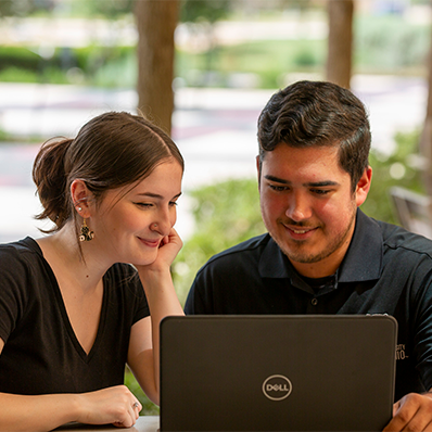 two students at laptop
