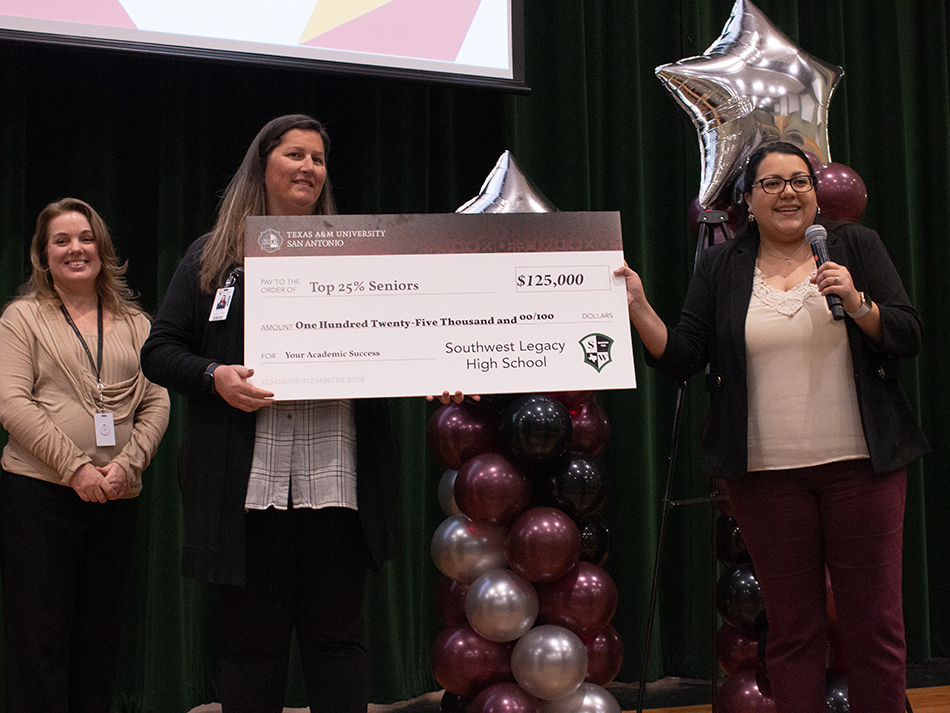 Staff Holding Scholarship Check