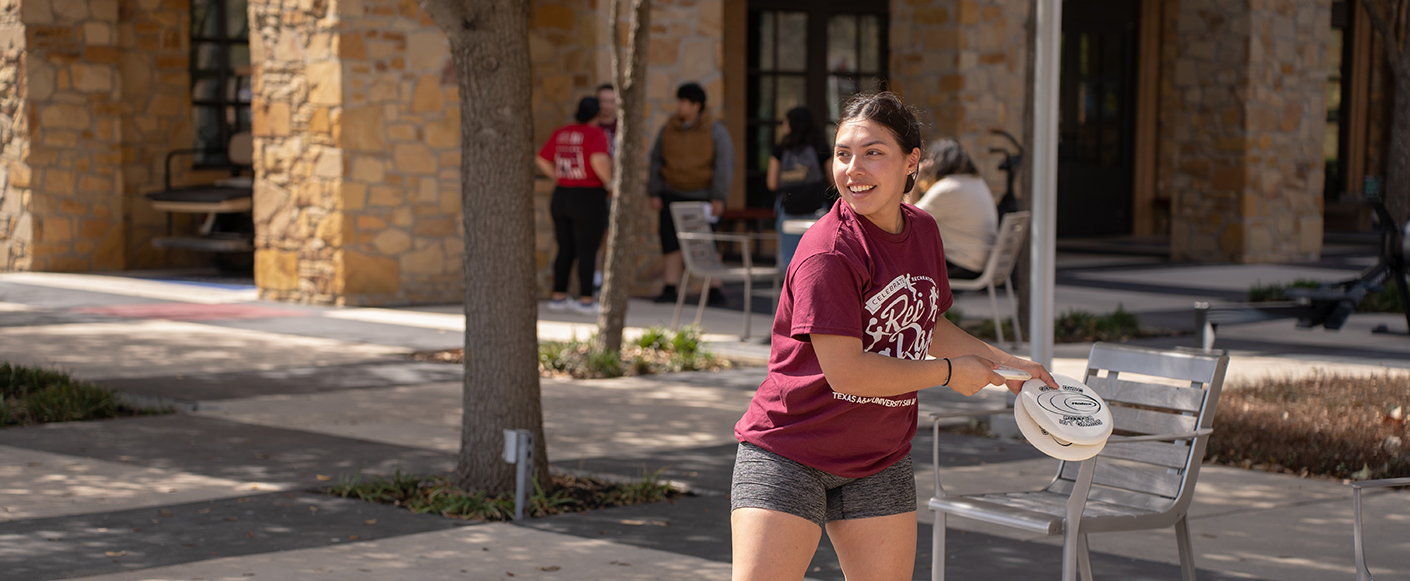 Student Playing Frisbee