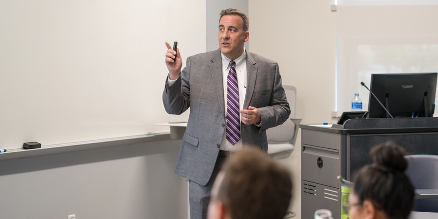 Speaker Giving a Presentation to Faculty Members