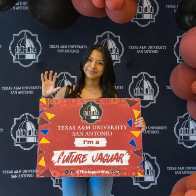 Female student holding a “Future Jaguar” sign 