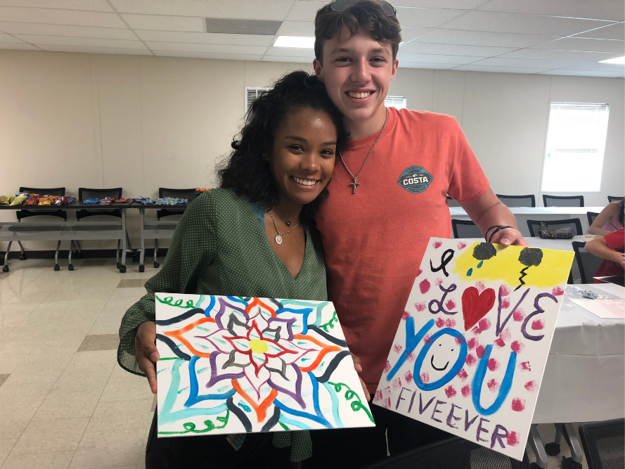 Students showing paintings