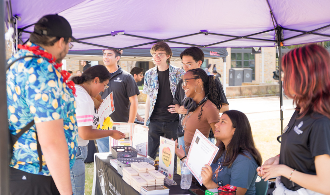 Students at an event greeting the office of First-Year Experience